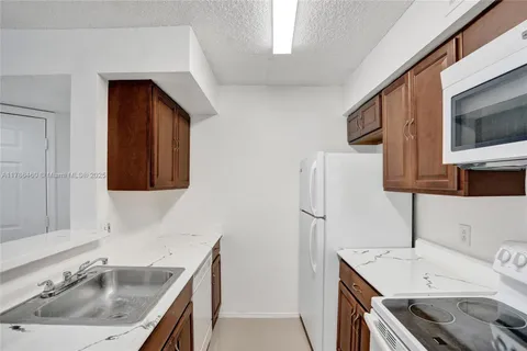 a kitchen with a sink stove and microwave