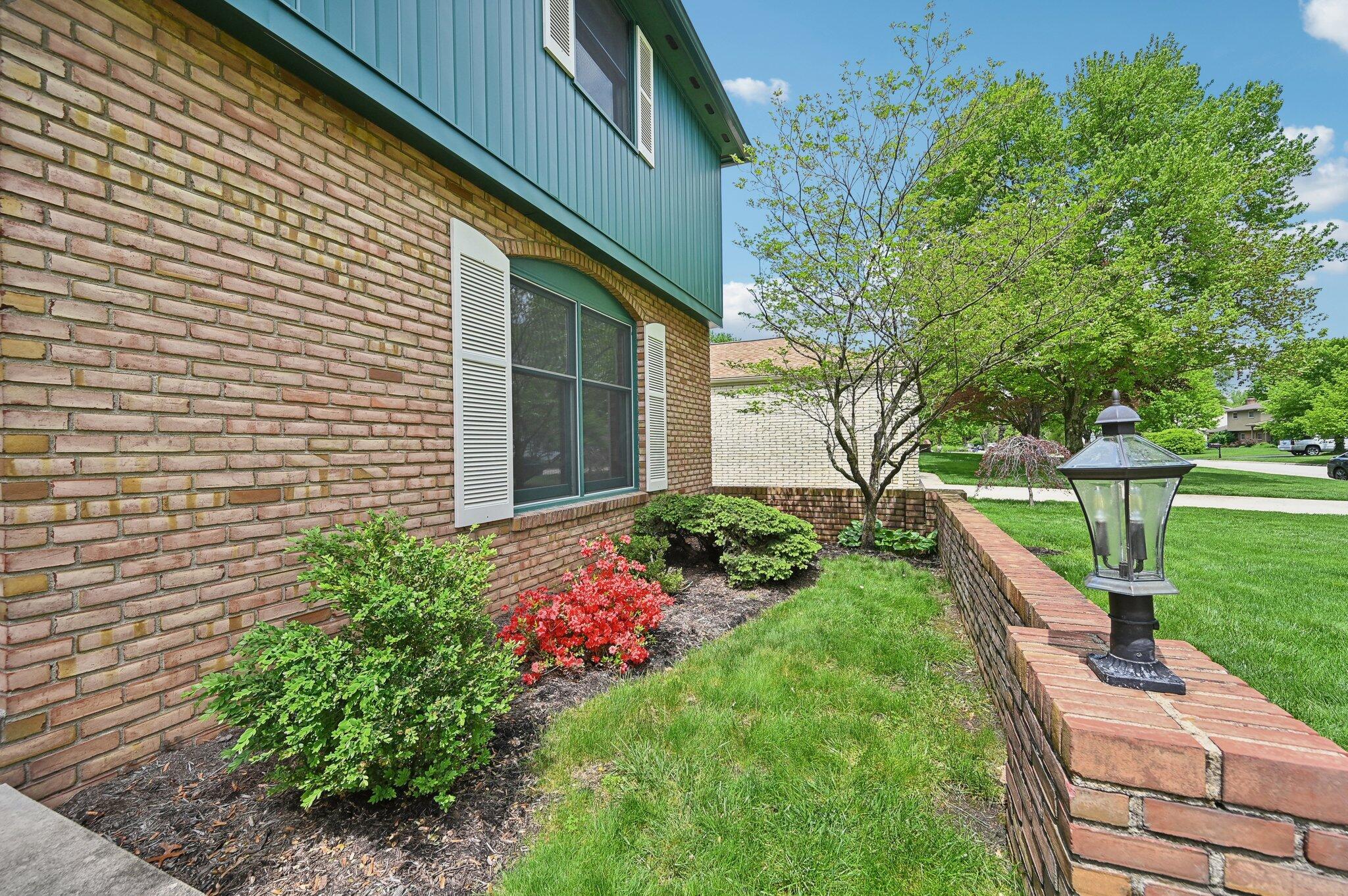 5917 Rocky Rill Road Columbus, OH 43235 - Photo 4 of 47 Front Flower Bed & Sidewalk
Mulch and blooming shrubs, and vibrant flowers lead toward the front entry—an inviting first impression.