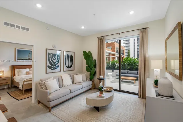 a living room with furniture and a large window