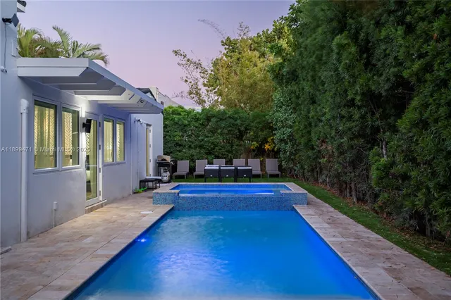 a front view of a house with yard and balcony