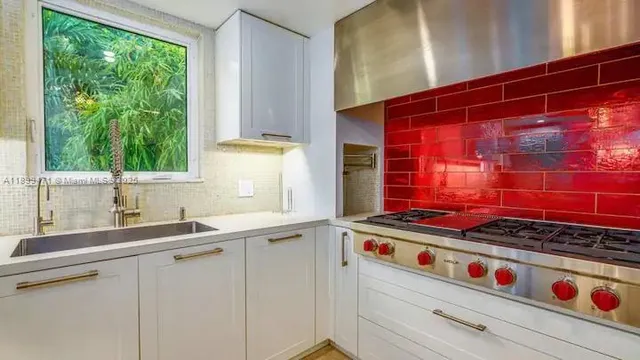 a kitchen with stainless steel appliances granite countertop a stove and a refrigerator