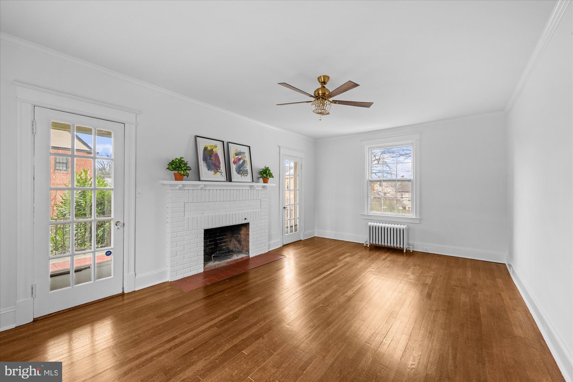 3206 Morrison Street Northwest Washington, DC 20015 - Photo 3 of 17 a view of empty room with wooden floor and fireplace