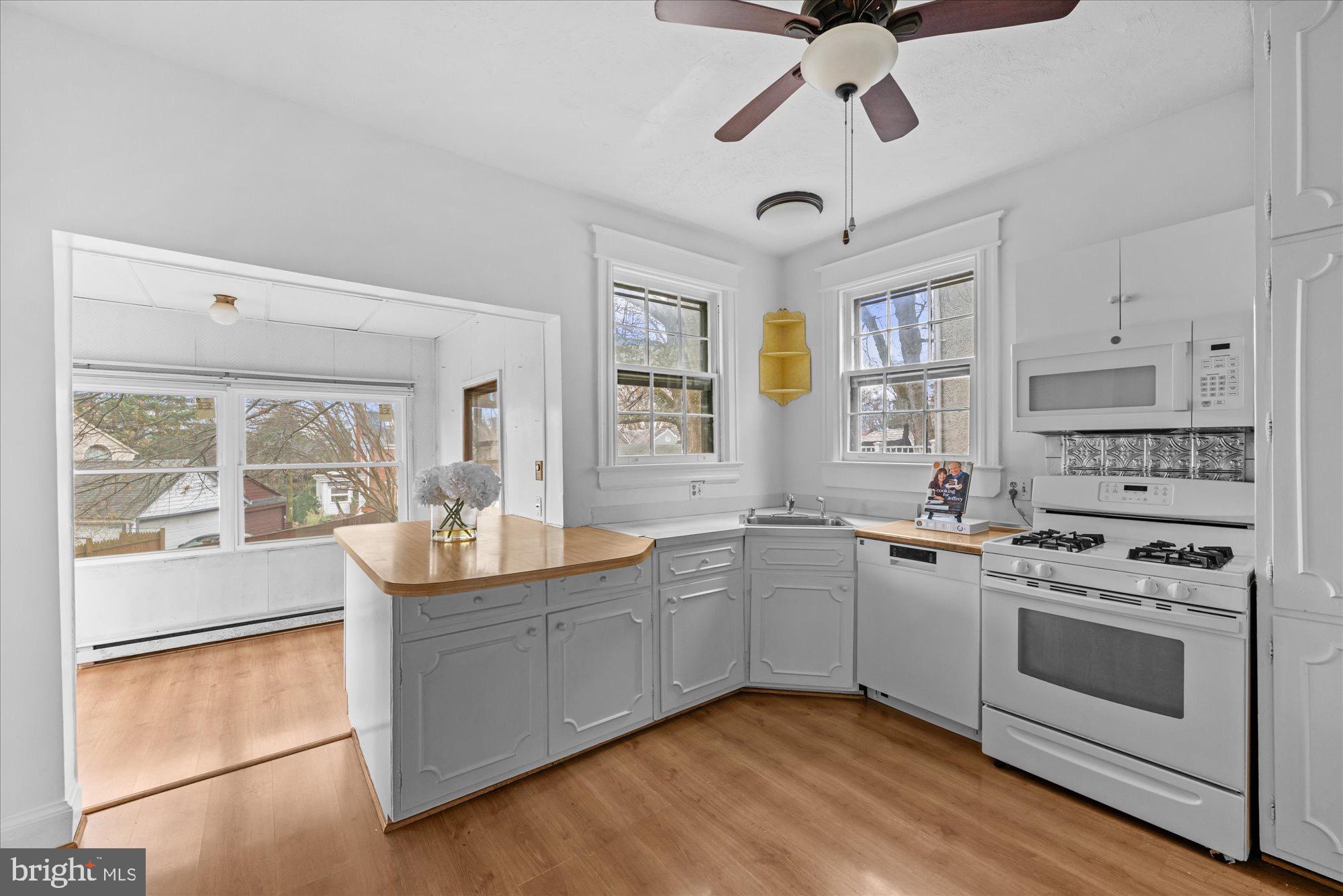 3206 Morrison Street Northwest Washington, DC 20015 - Photo 8 of 17 a kitchen with stainless steel appliances a stove sink and cabinets