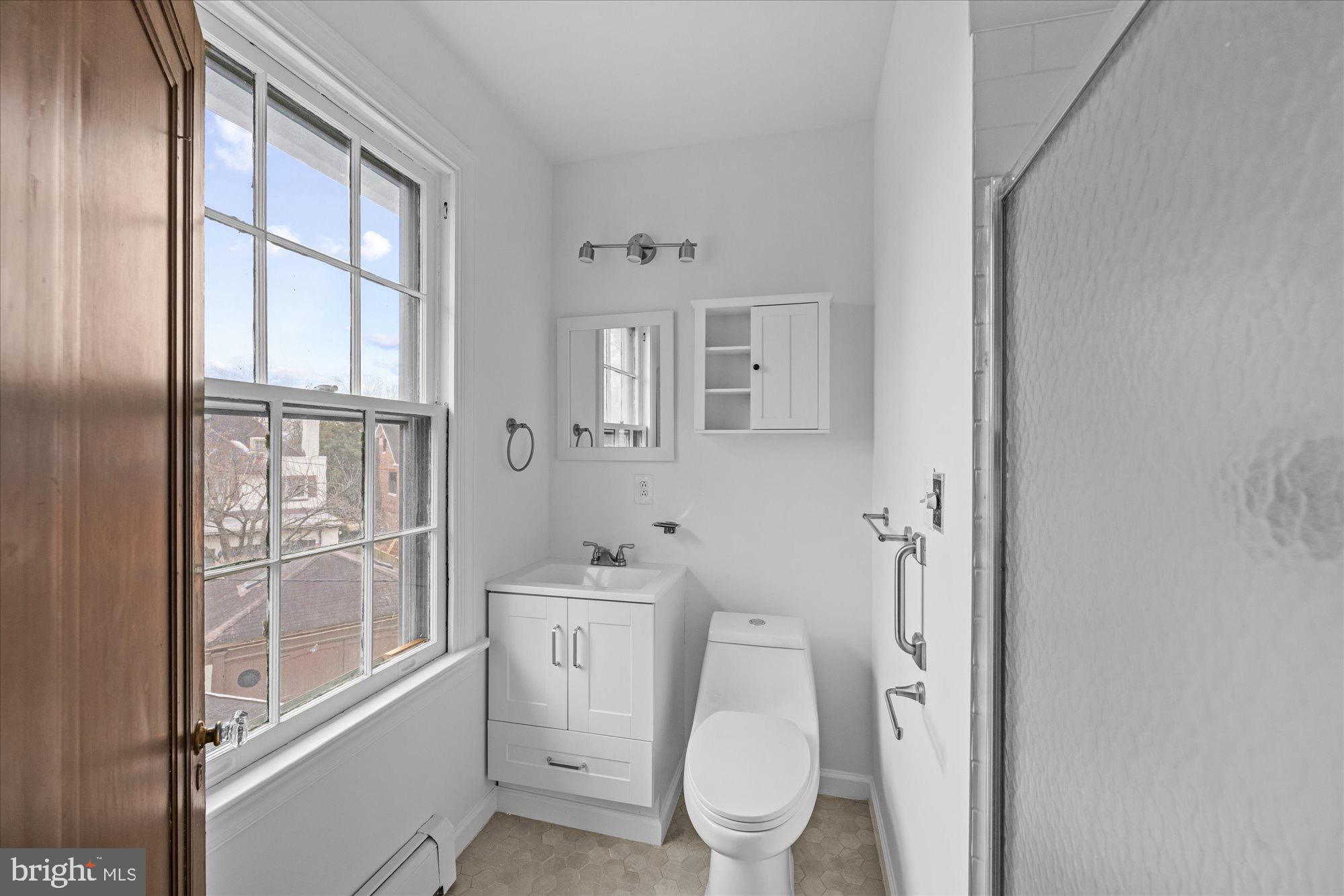 3206 Morrison Street Northwest Washington, DC 20015 - Photo 10 of 17 a bathroom with a toilet a sink and a large window