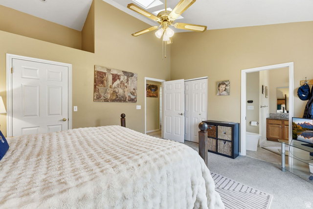 7930 Mustang Loop Road Park City, UT 84098 - Photo 10 of 23 Bedroom with vaulted ceiling, carpet flooring, a skylight, connected bathroom, and a ceiling fan