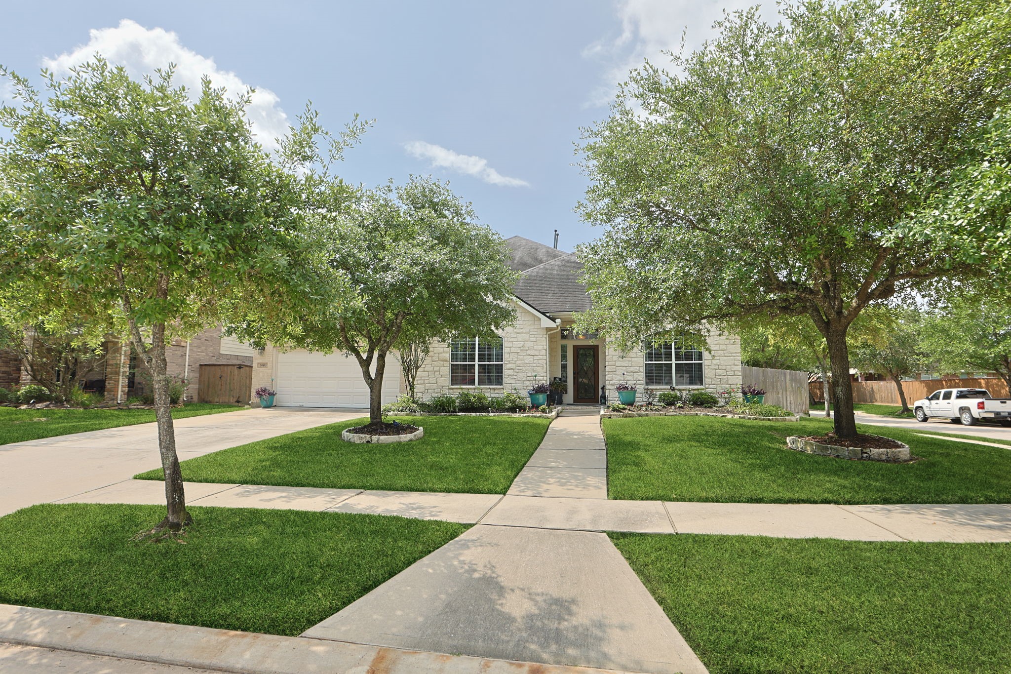 20410 Misty Crossing Lane Spring, TX 77379 - Photo 1 of 50 Charming single-story home with a manicured lawn, stone facade, and a welcoming front porch. The property features a spacious driveway, mature trees, and a well-maintained lawn, creating excellent curb appeal.