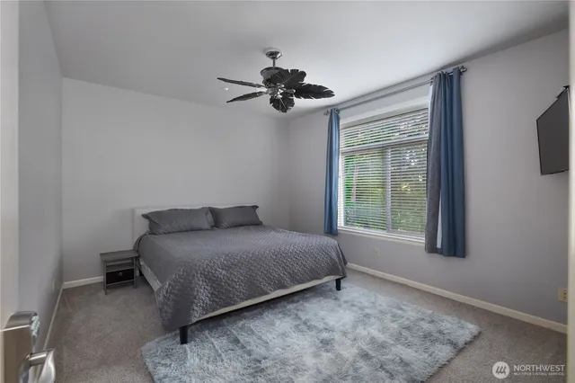 a bedroom with a bed a dresser and a window