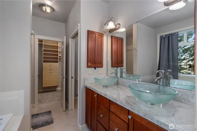 a bathroom with a double vanity sink and a mirror