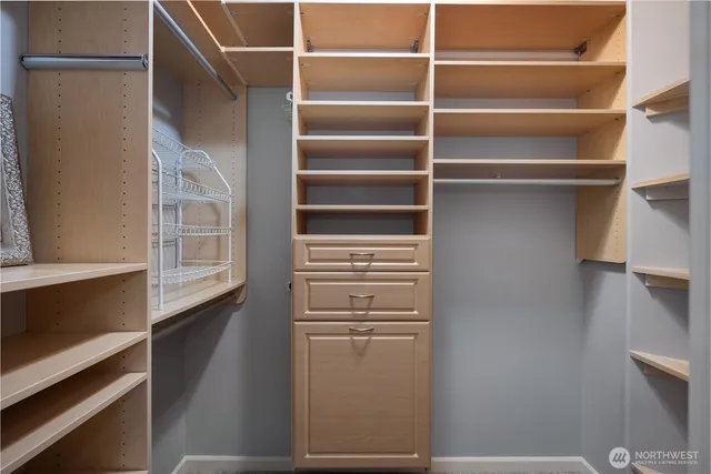 a view of walk in closet with empty racks