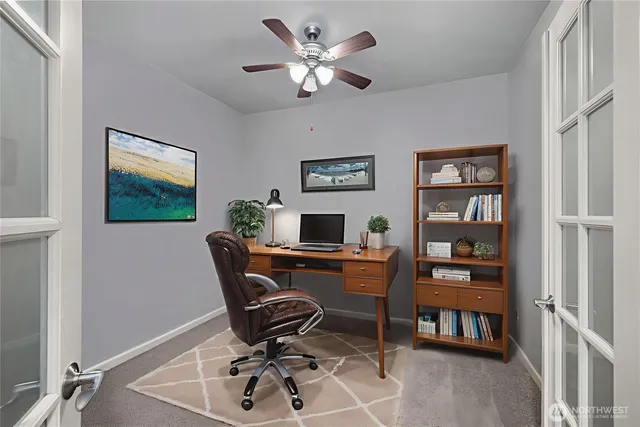a work room with furniture and a bookshelf