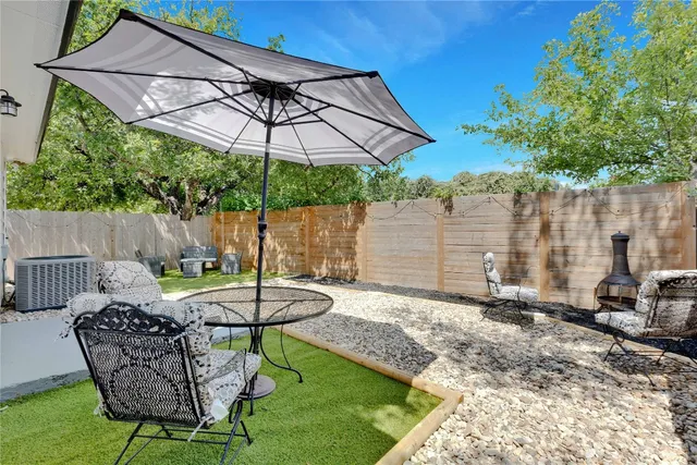 a view of backyard with a patio and outdoor seating