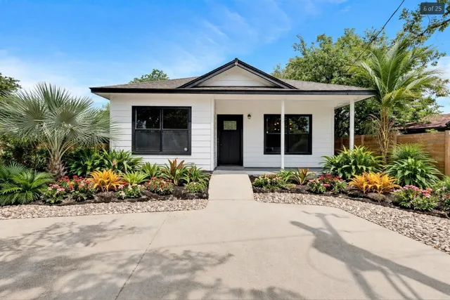 a front view of a house with a garden