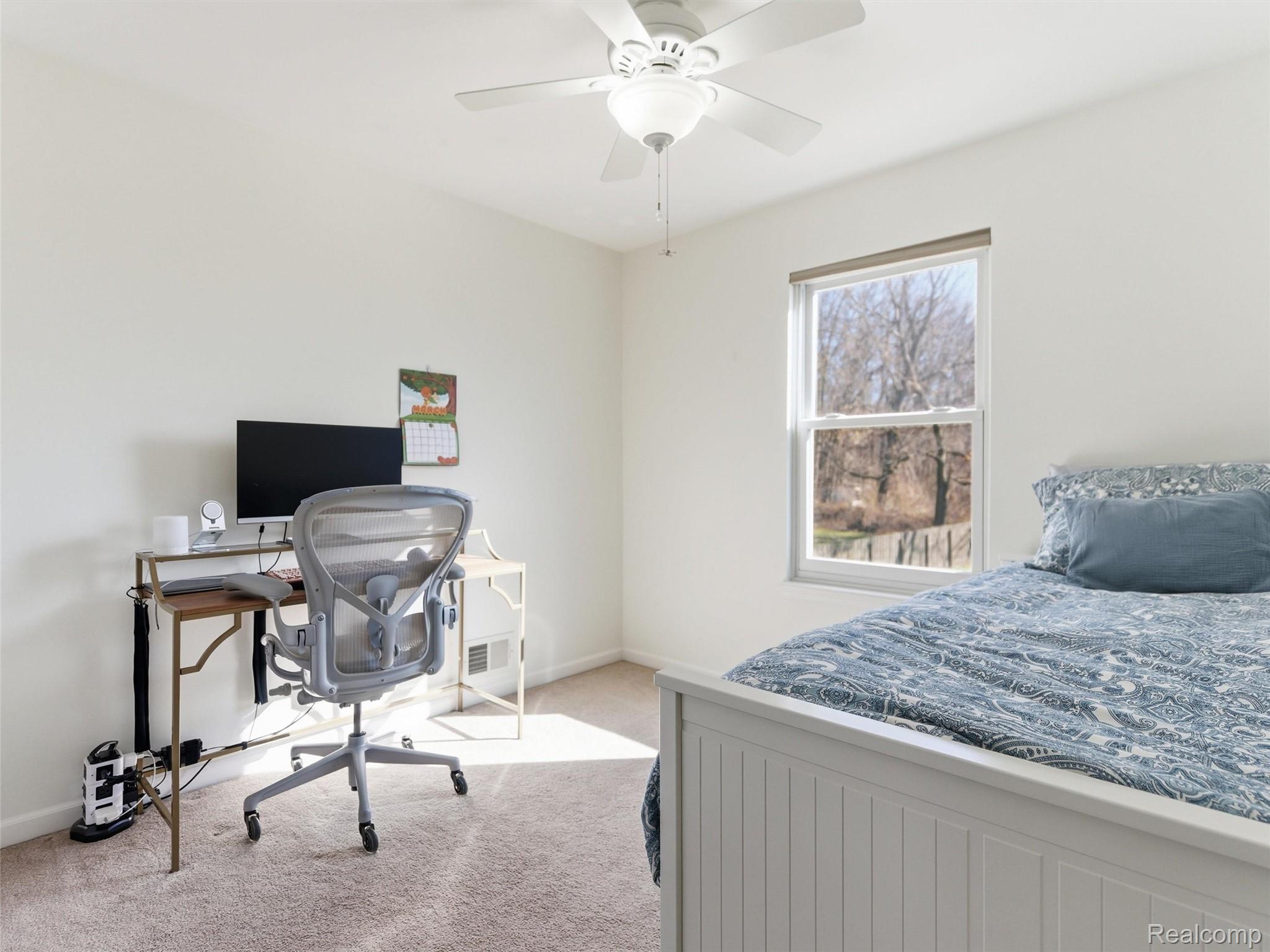 7640 Clintonville Road Clarkston, MI 48348 - Photo 20 of 27 Bedroom with an office area, light carpet, and a ceiling fan