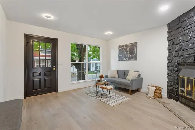 a view of a house with a big yard and large trees