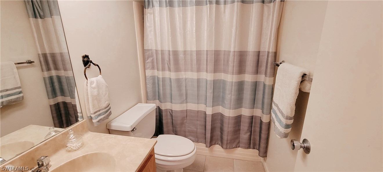 1022 Manatee Road, Unit D206 Naples, FL 34114 - Photo 17 of 21 a white toilet sitting next to a bathroom sink