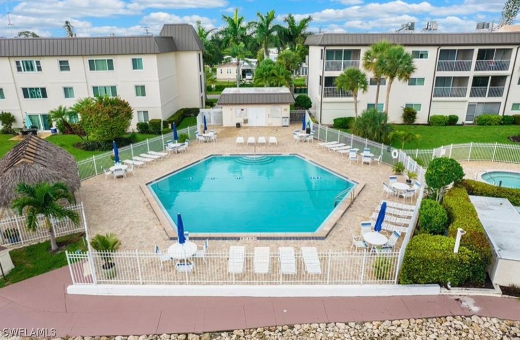 1022 Manatee Road, Unit D206 Naples, FL 34114 - Photo 20 of 21 a view of swimming pool with outdoor seating and plants