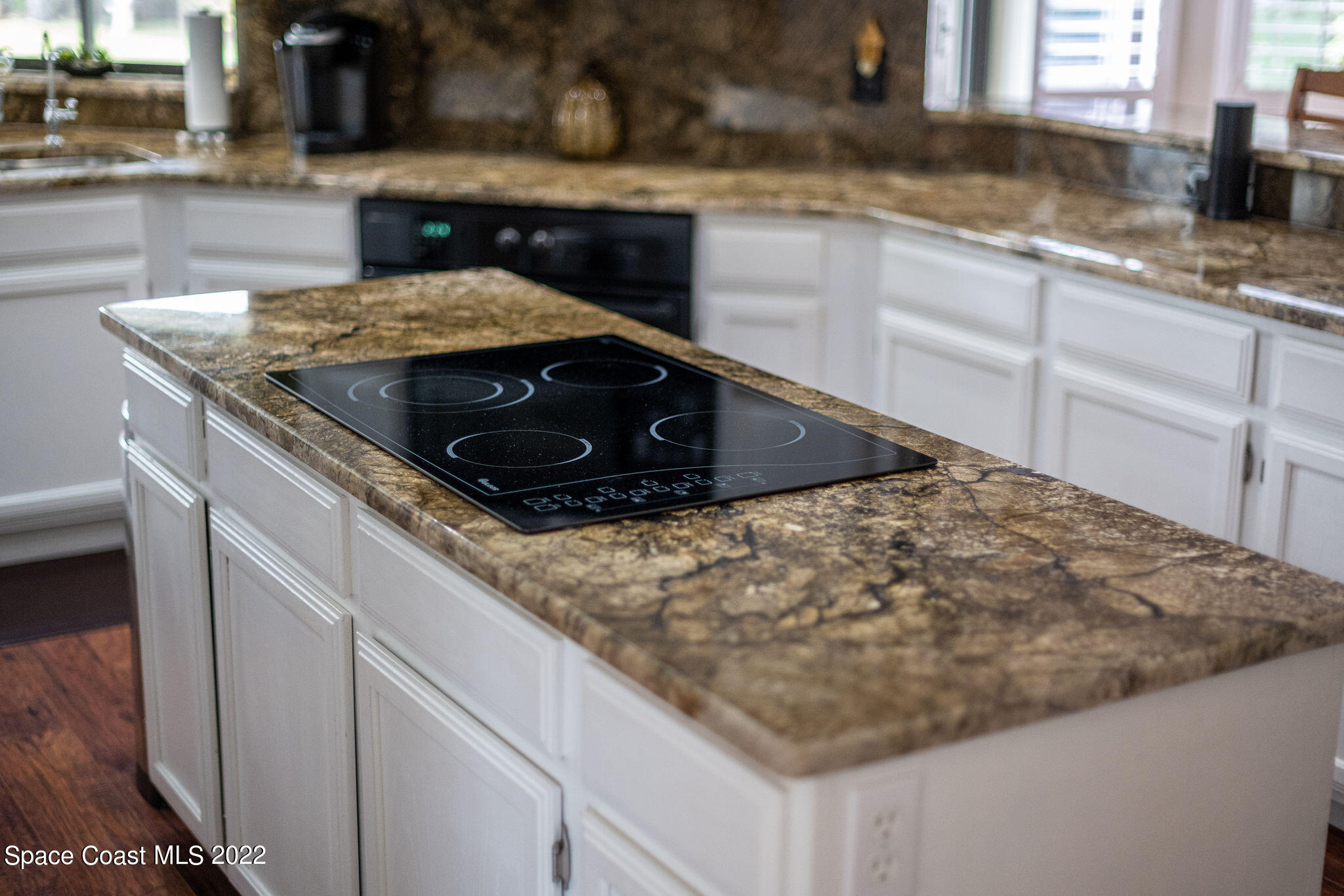 3500 Corey Road Malabar, FL 32950 - Photo 102 of 122 a kitchen with granite countertop a sink a stove and cabinets