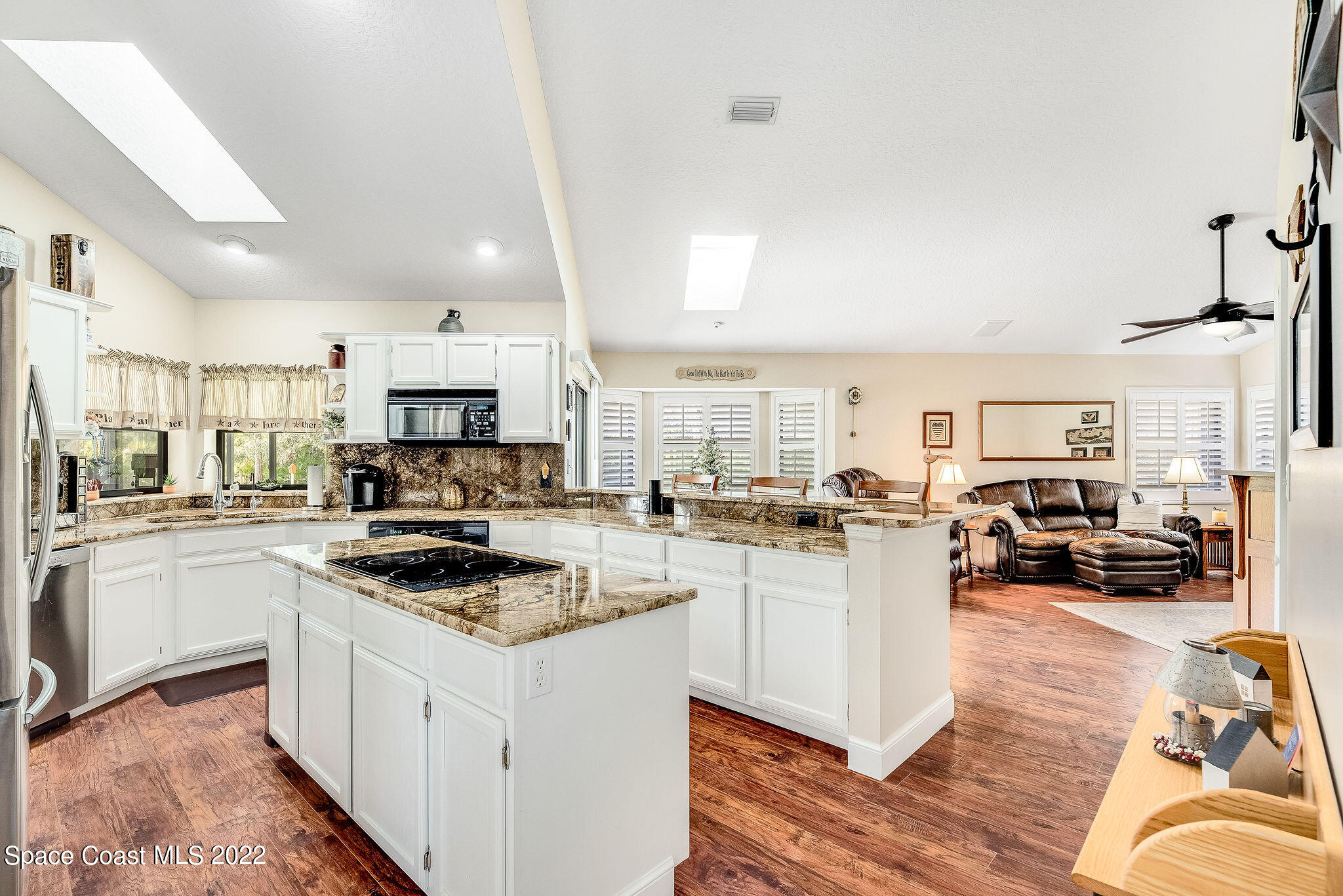 3500 Corey Road Malabar, FL 32950 - Photo 21 of 122 a kitchen with white cabinets and appliances