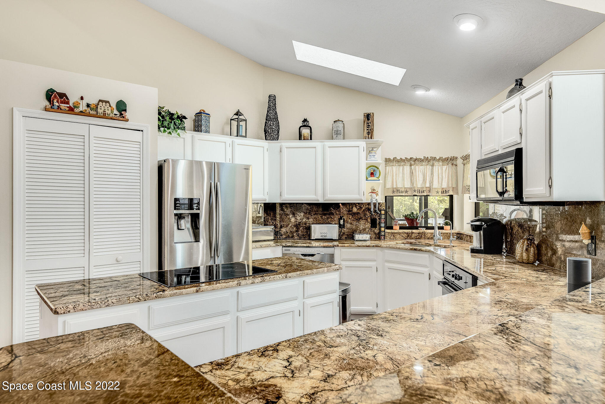 3500 Corey Road Malabar, FL 32950 - Photo 23 of 122 a kitchen with stainless steel appliances granite countertop a refrigerator sink and white cabinets
