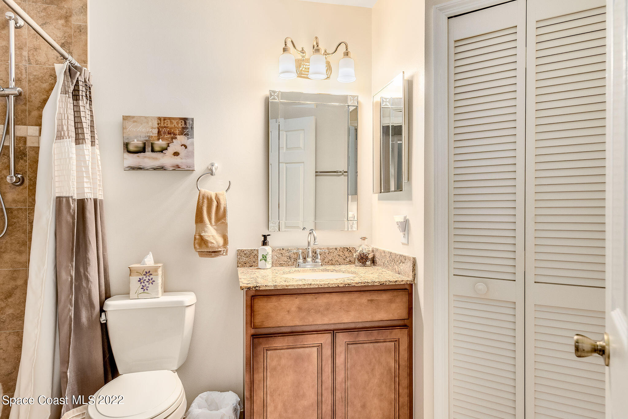 3500 Corey Road Malabar, FL 32950 - Photo 34 of 122 a bathroom with a sink a toilet and a mirror