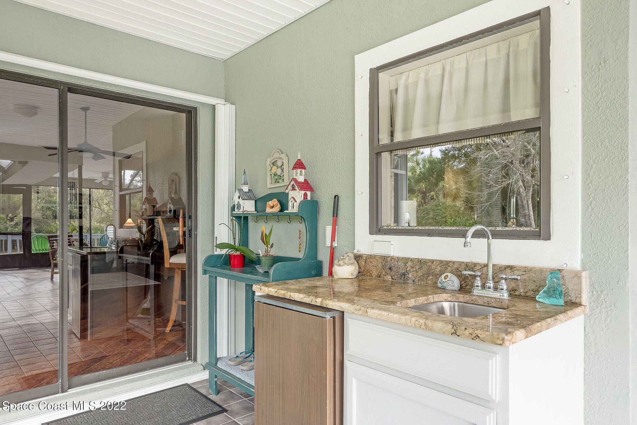 3500 Corey Road Malabar, FL 32950 - Photo 41 of 122 a bathroom with a granite countertop sink and a mirror