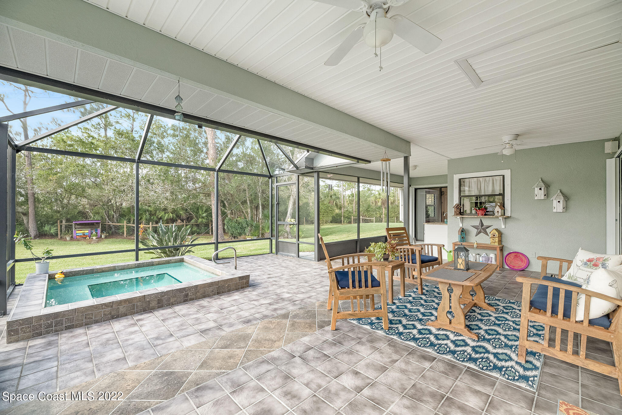 3500 Corey Road Malabar, FL 32950 - Photo 47 of 122 a living room filled with furniture and a garden