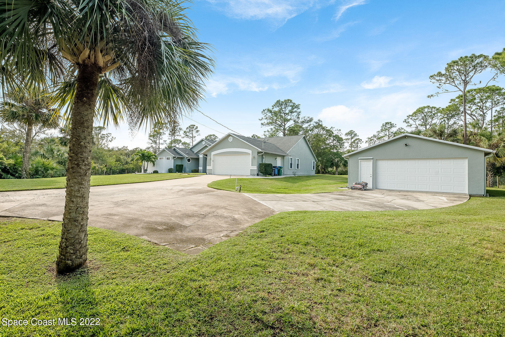 3500 Corey Road Malabar, FL 32950 - Photo 61 of 122 a view of a house with a yard and a garage