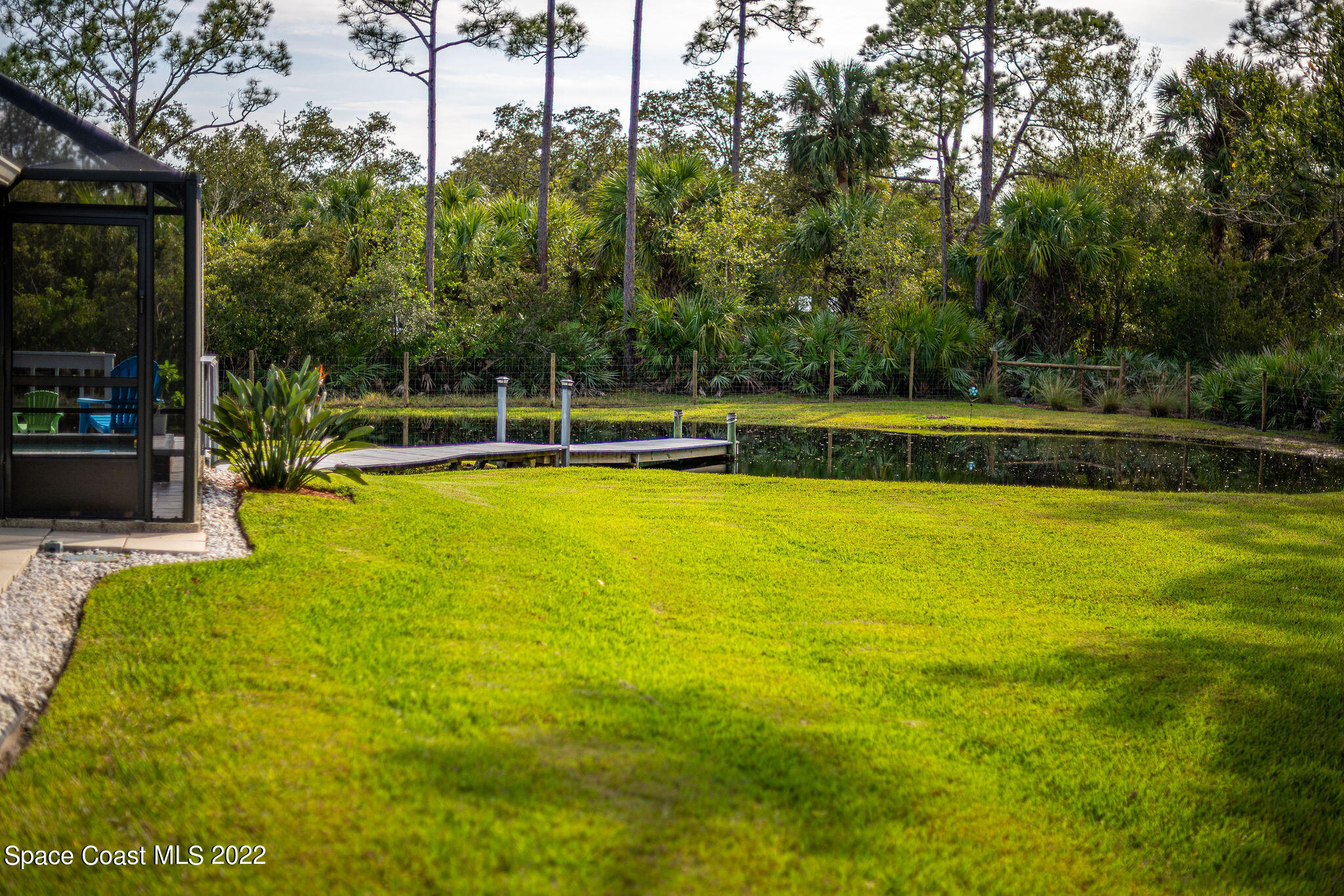 3500 Corey Road Malabar, FL 32950 - Photo 74 of 122 a view of a swimming pool with lawn chairs under an umbrella