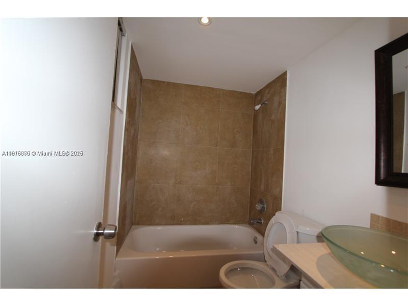 525 West 69th Street, Unit 209 Hialeah, FL 33014 - Photo 2 of 3 a bathroom with a sink and a mirror
