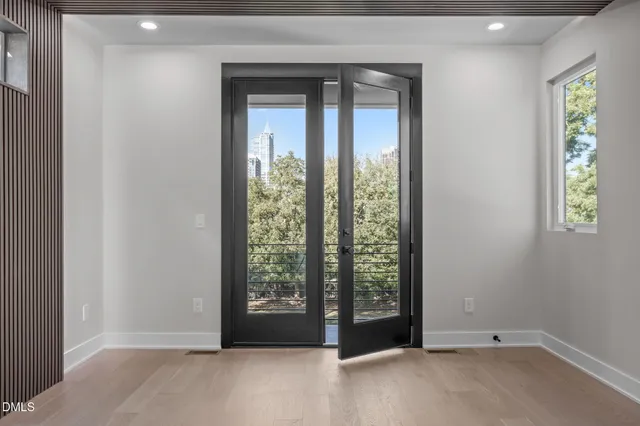 en empty room with wooden floor and a ceiling fan