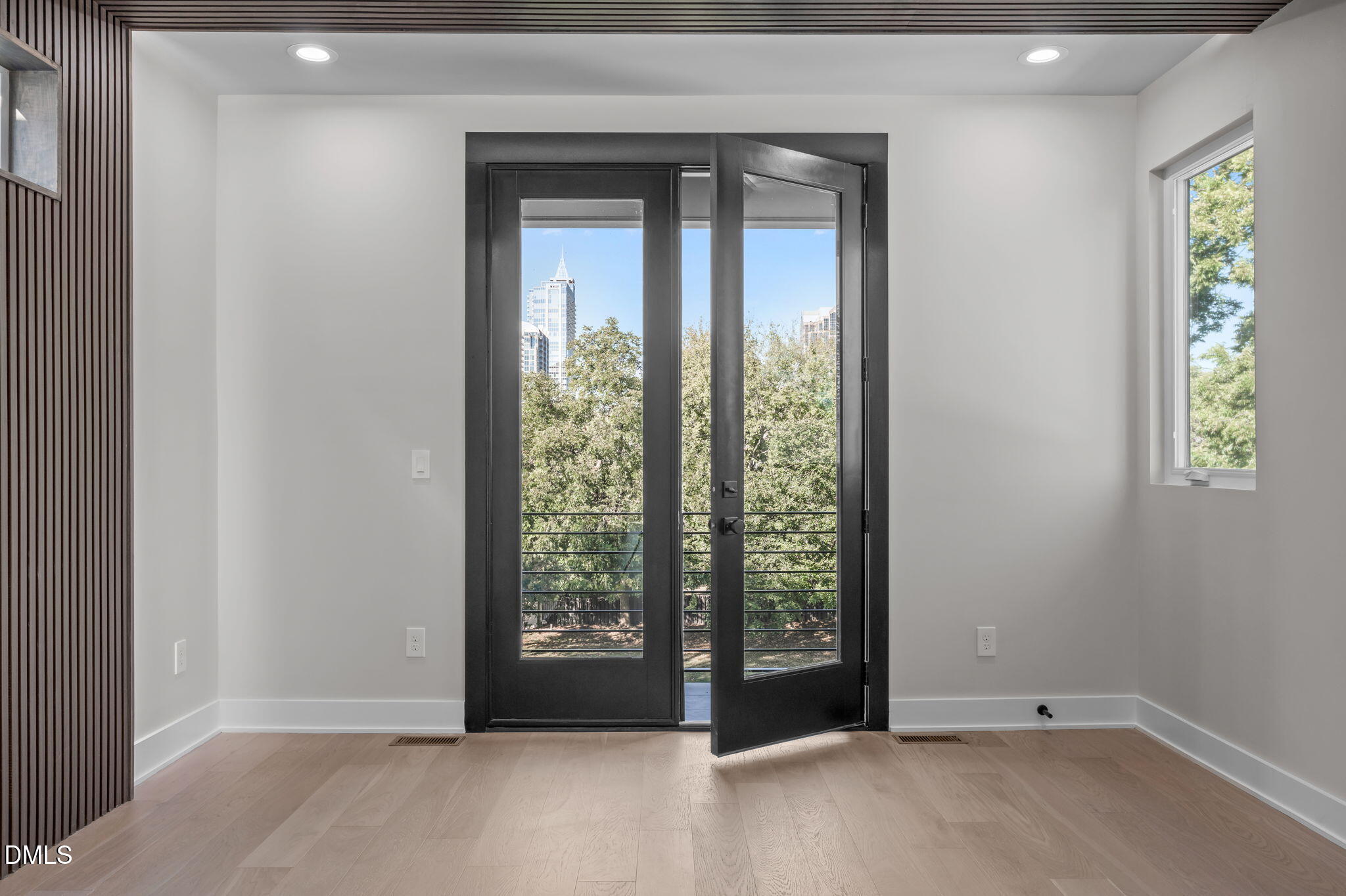 226 Woodsborough Place Raleigh, NC 27601 - Photo 16 of 42 an empty room with windows and lake view
