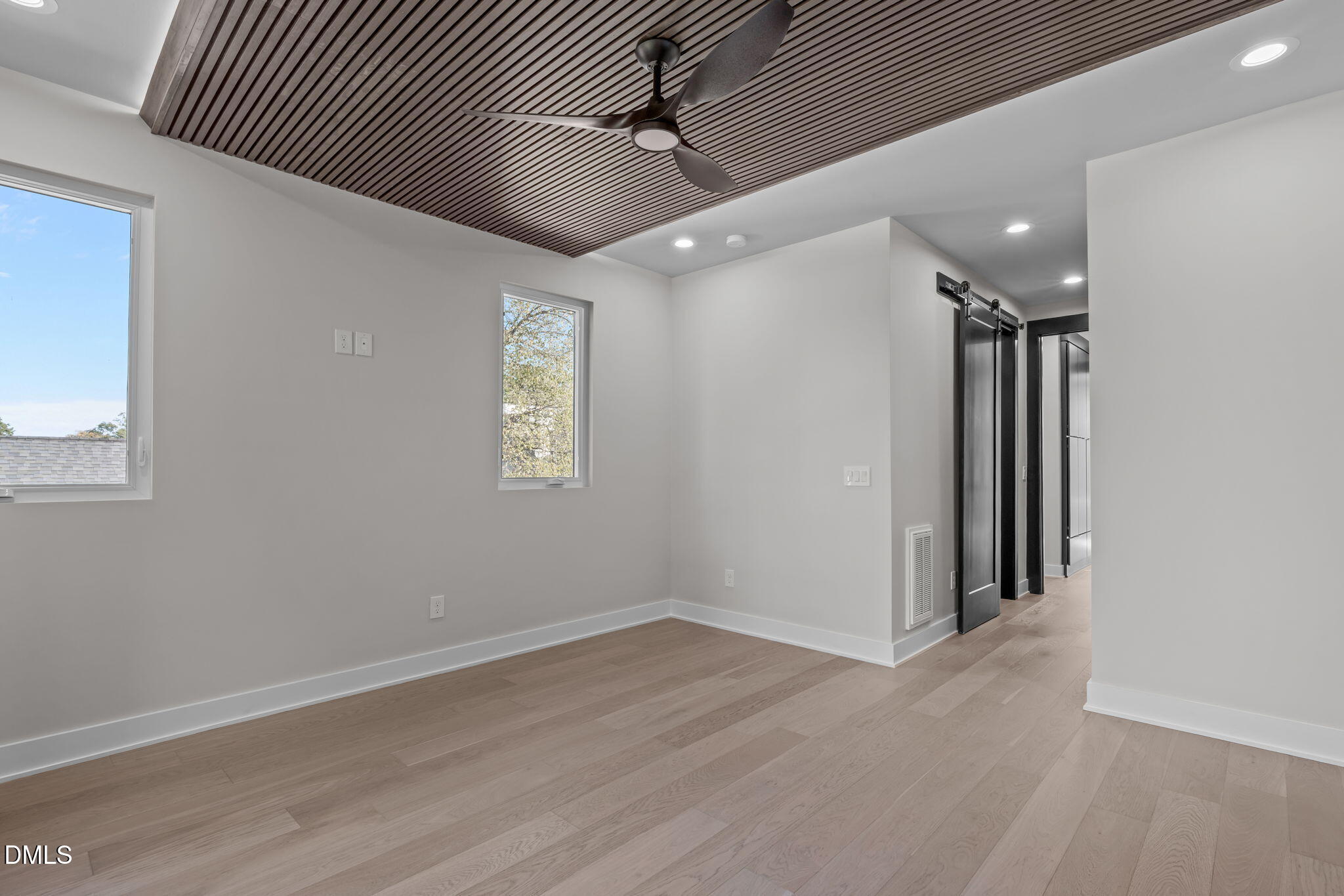 226 Woodsborough Place Raleigh, NC 27601 - Photo 18 of 42 an empty room with wooden floor and windows