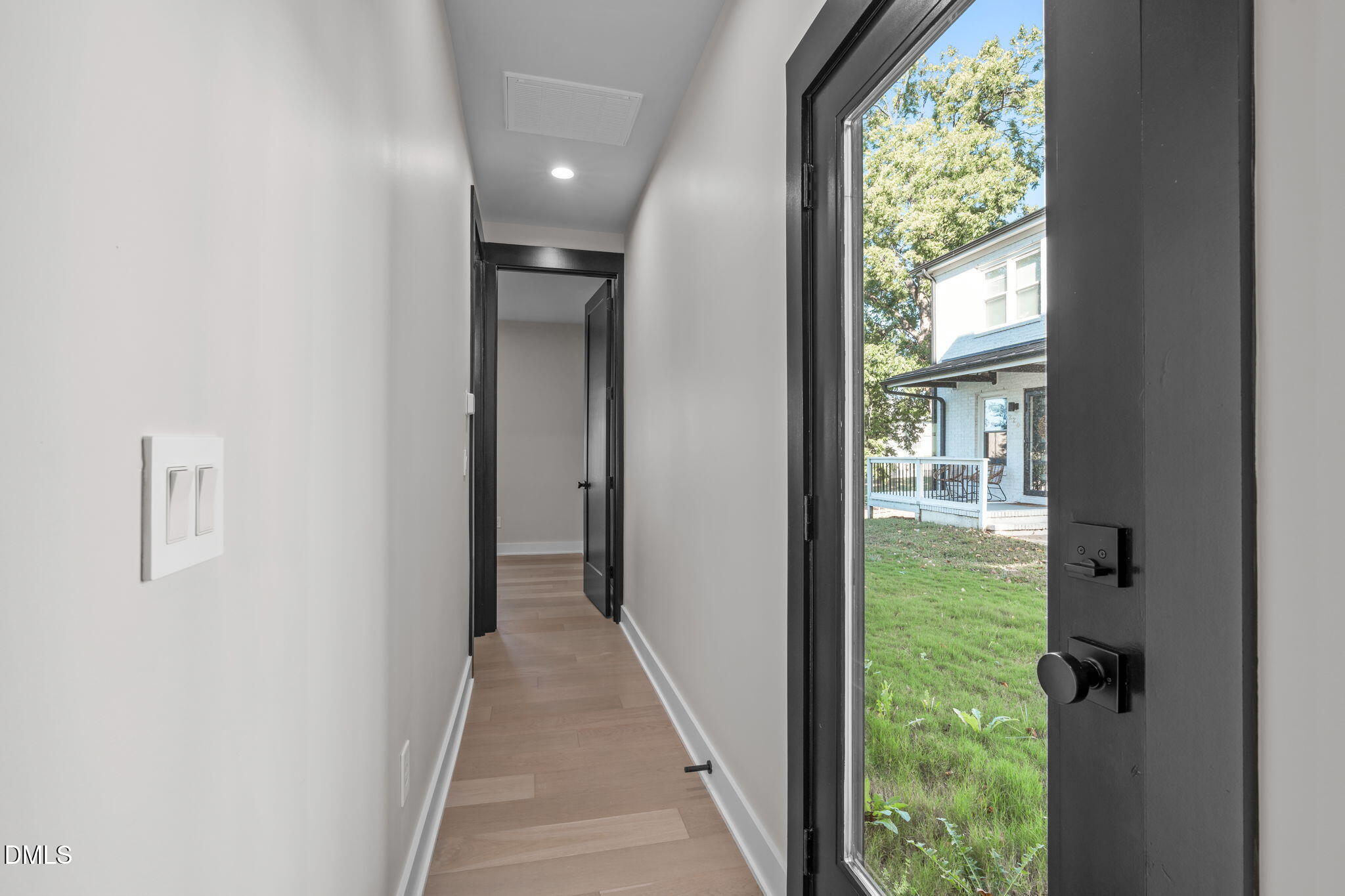 226 Woodsborough Place Raleigh, NC 27601 - Photo 23 of 42 a view of hallway with a large window and stairs