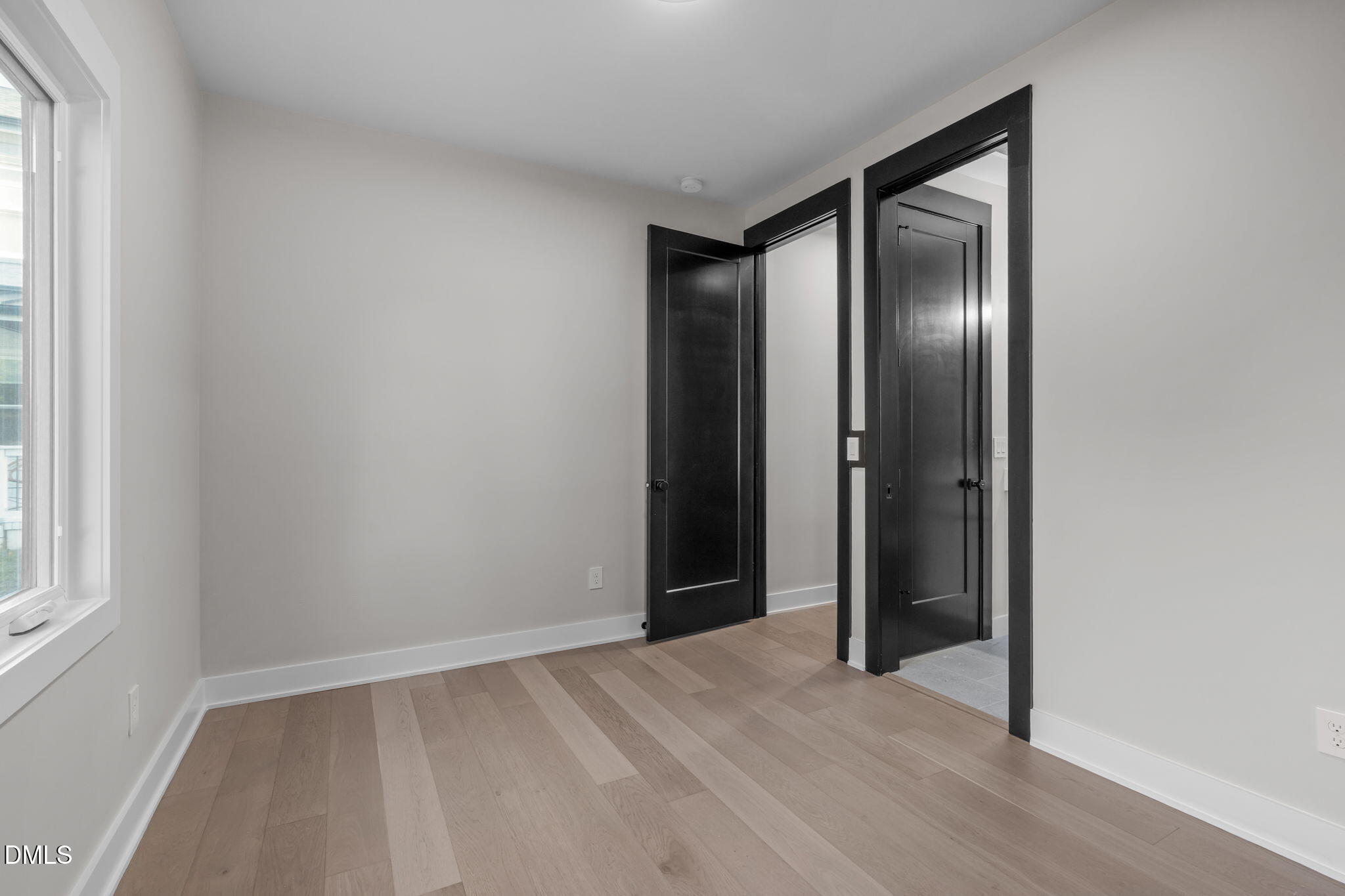 226 Woodsborough Place Raleigh, NC 27601 - Photo 25 of 42 an empty room with wooden floor and windows