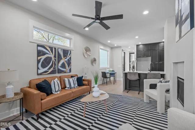 a living room with furniture and a ceiling fan