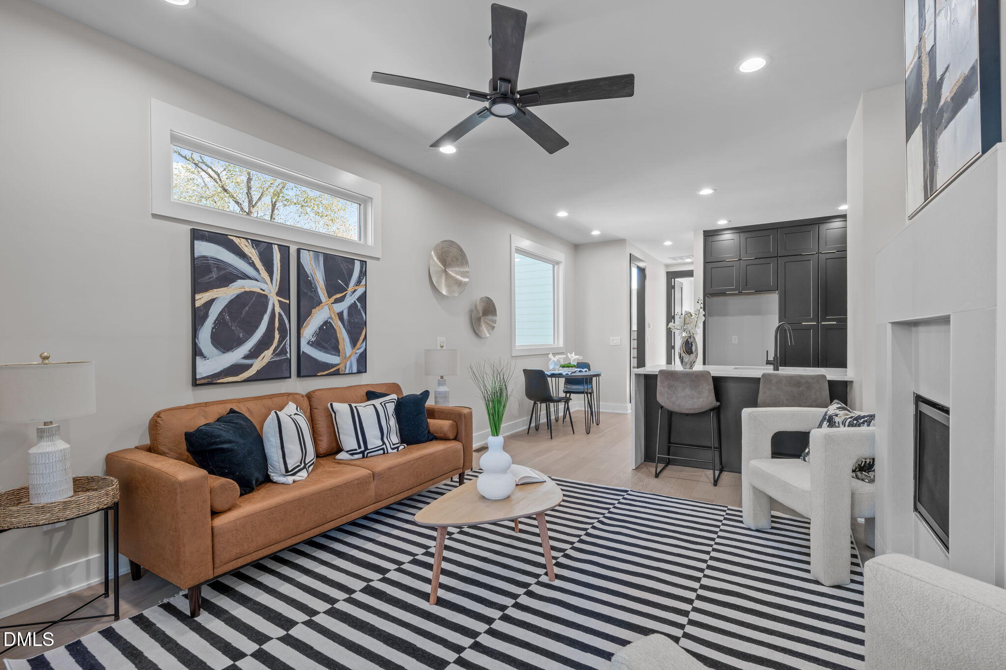 226 Woodsborough Place Raleigh, NC 27601 - Photo 6 of 42 a living room with furniture and a ceiling fan