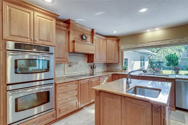 a kitchen with appliances cabinets and a sink