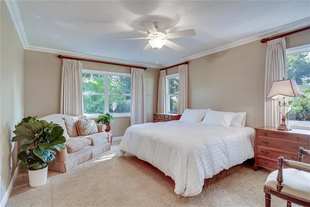 a spacious bedroom with a bed and a chandelier