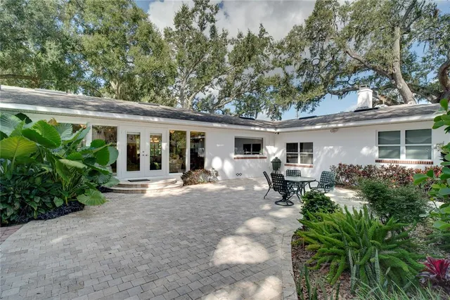 a view of a house with sitting area and garden