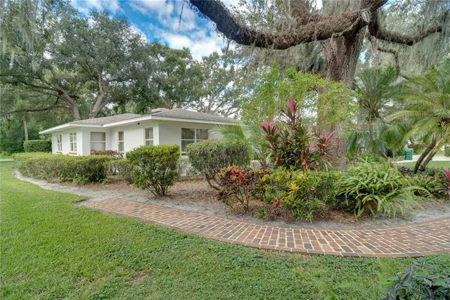 a front view of a house with yard and green space