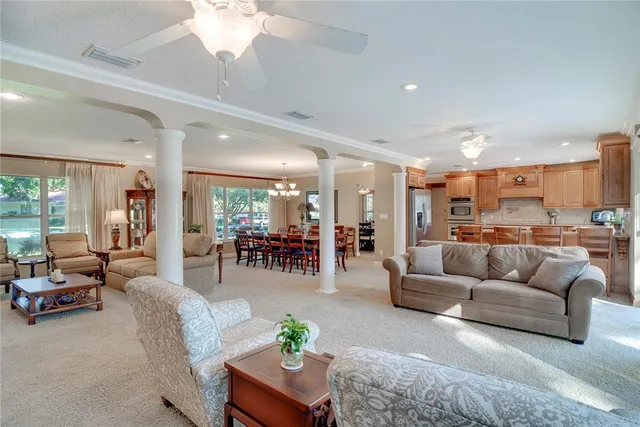a living room with furniture and kitchen view