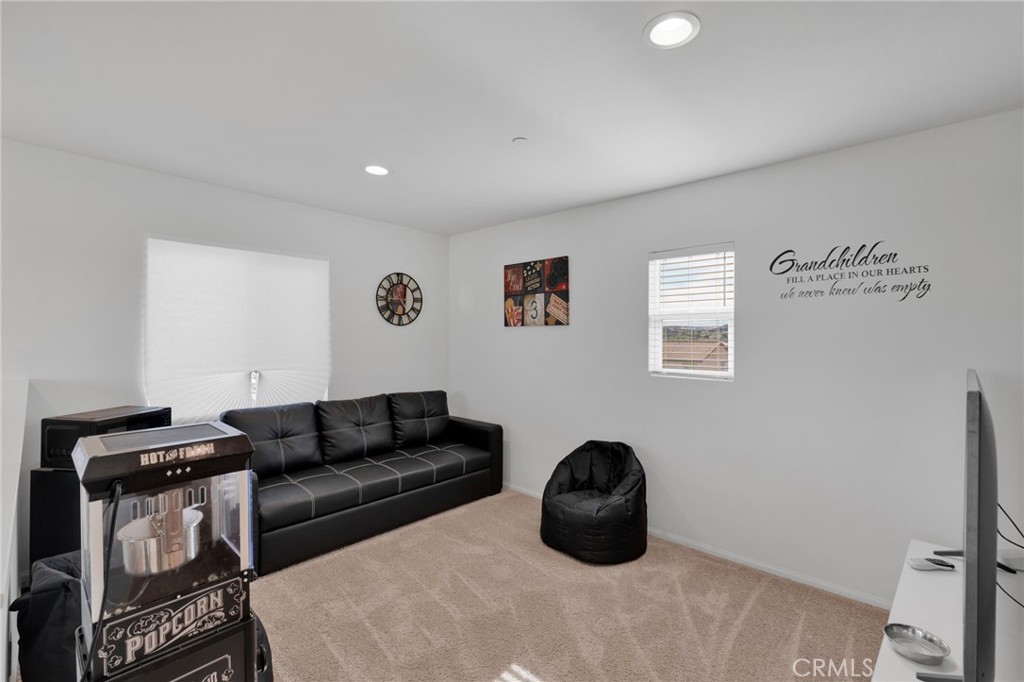 35153 Webb Place Beaumont, CA 92223 - Photo 20 of 42 a living room with furniture a rug and a wooden floor