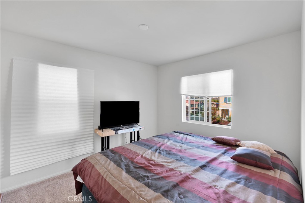 35153 Webb Place Beaumont, CA 92223 - Photo 27 of 42 a bedroom with a bed television and a window