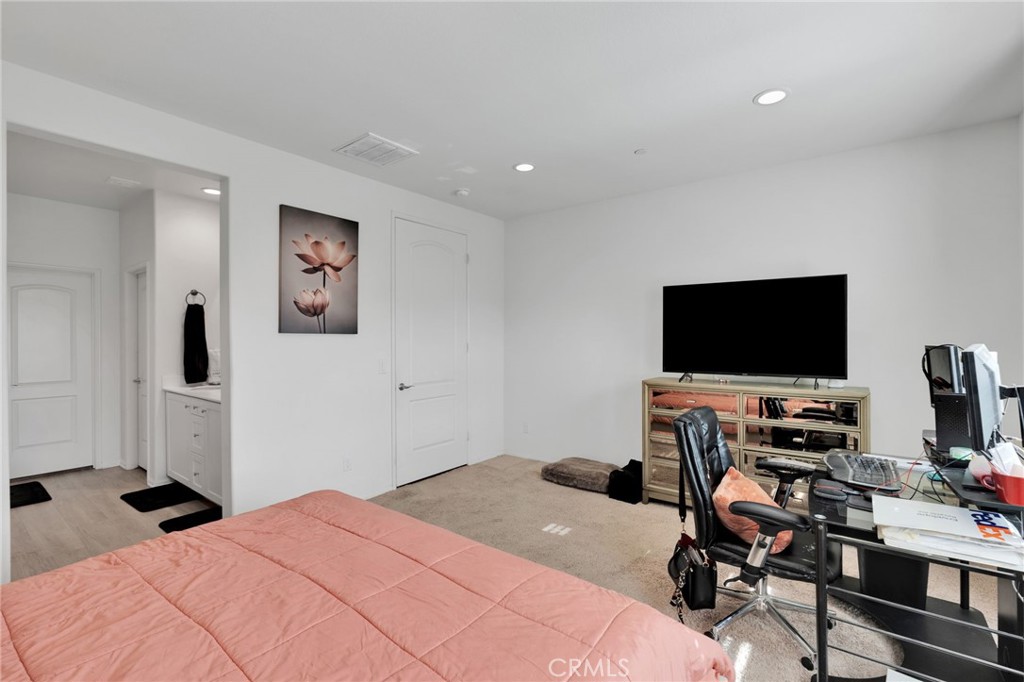 35153 Webb Place Beaumont, CA 92223 - Photo 30 of 42 a bedroom with a bed and a flat screen tv