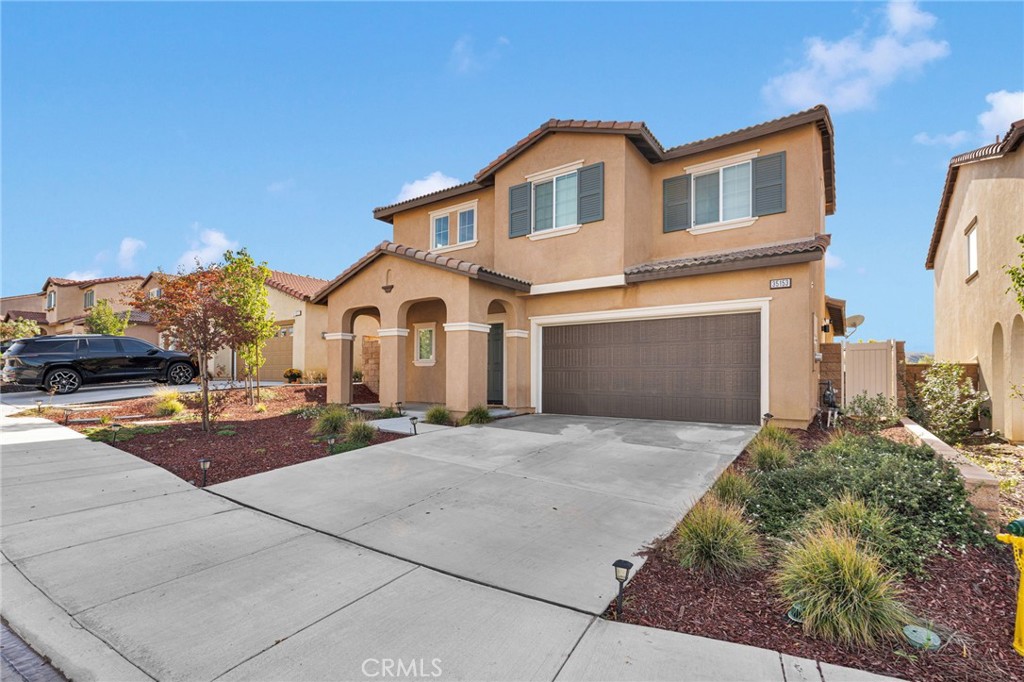 35153 Webb Place Beaumont, CA 92223 - Photo 3 of 42 a front view of a house with a yard and garage