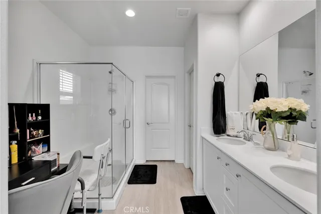 a bathroom with double vanity sink and a mirror