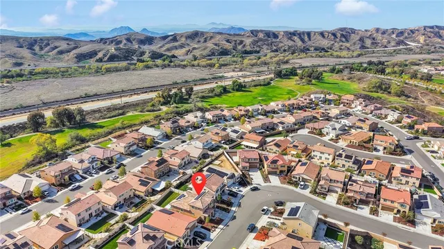 an aerial view of a house with a yard