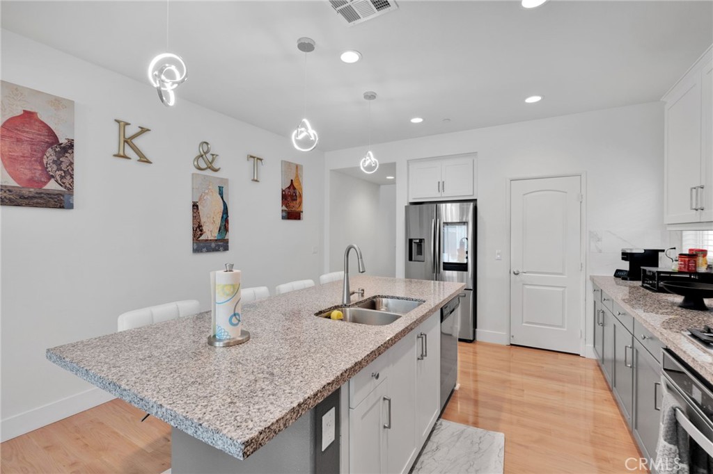 35153 Webb Place Beaumont, CA 92223 - Photo 9 of 42 a kitchen with granite countertop a sink and cabinets