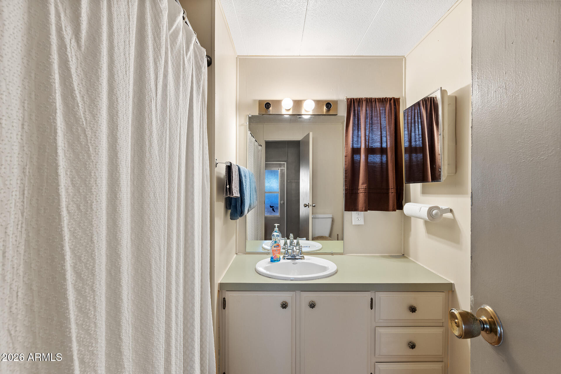 10540 East Apache Trail, Unit 151 Apache Junction, AZ 85120 - Photo 13 of 31 a bathroom with a double vanity sink and a mirror
