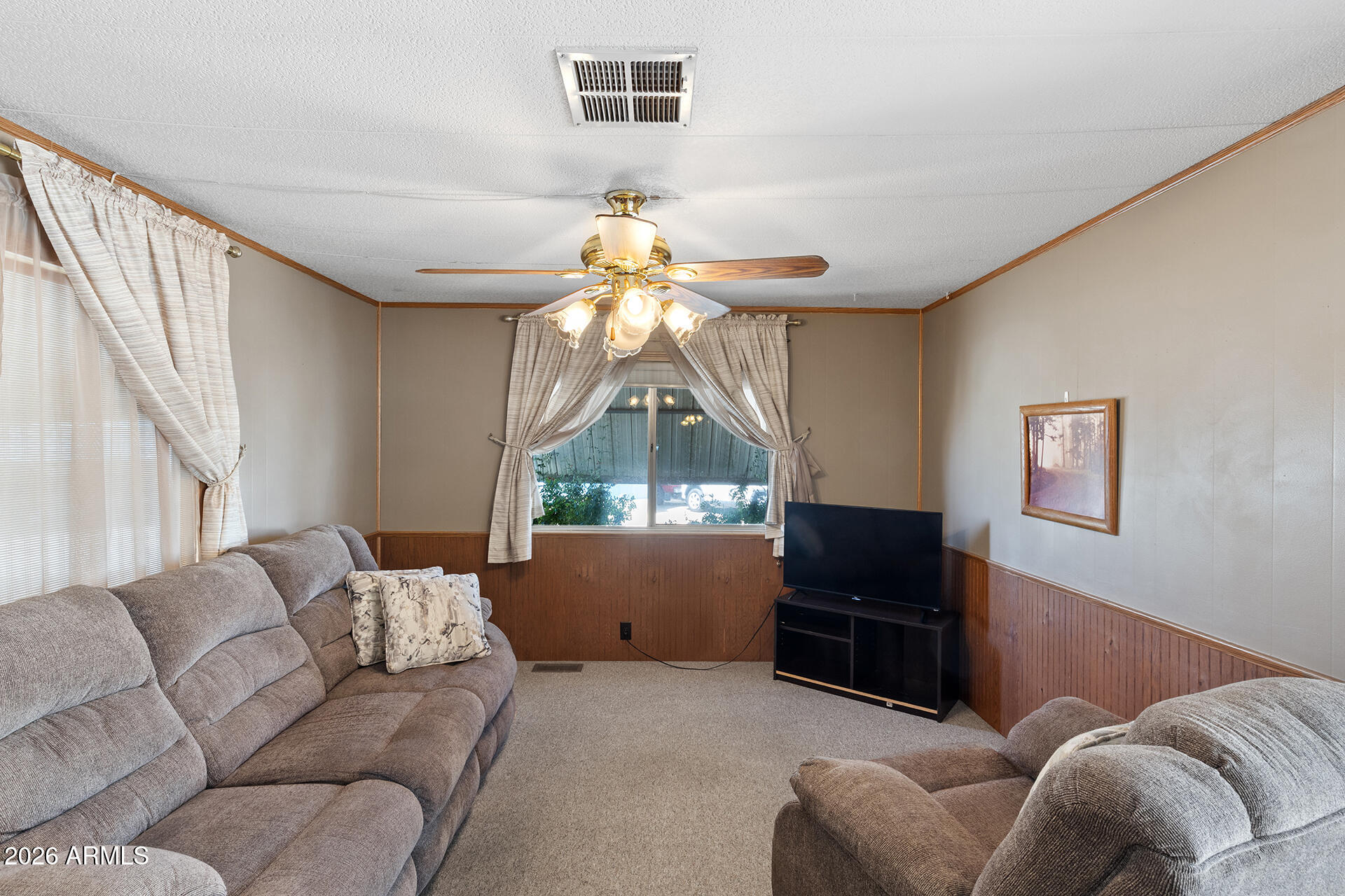 10540 East Apache Trail, Unit 151 Apache Junction, AZ 85120 - Photo 20 of 31 a living room with furniture a window and a flat screen tv